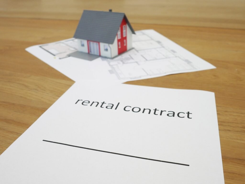 Property manager reviewing a real estate renting contract with a tenant, ensuring all terms are clearly outlined and agreed upon.